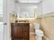 Bathroom featuring wood vanity with granite counter and decorative wall tile at 13710 Westshire Dr, Tampa, FL 33618