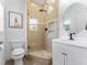 Bathroom featuring a glass enclosed shower, modern fixtures, and updated vanity at 13710 Westshire Dr, Tampa, FL 33618