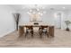 Inviting dining room with modern chandelier, ample seating, and light hardwood flooring at 13710 Westshire Dr, Tampa, FL 33618