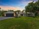 Well-maintained home with modern features, a manicured lawn, and professional landscaping at 13710 Westshire Dr, Tampa, FL 33618