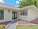 Close up of the home's entrance, featuring double doors and well-maintained landscaping at 13710 Westshire Dr, Tampa, FL 33618