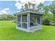 Relax in this charming screened gazebo overlooking a serene pond, perfect for peaceful afternoons at 13710 Westshire Dr, Tampa, FL 33618