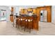 Well-equipped kitchen island and bar seating open to the pool view at 13710 Westshire Dr, Tampa, FL 33618