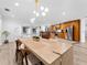 Open concept kitchen and dining area with pool views, stainless steel appliances, and spacious island at 13710 Westshire Dr, Tampa, FL 33618