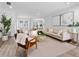 Bright living room featuring neutral tones, hardwood floors, and stylish contemporary furnishings at 13710 Westshire Dr, Tampa, FL 33618
