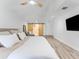 Bright main bedroom featuring light wood floors and a large sliding barn door at 13710 Westshire Dr, Tampa, FL 33618