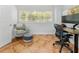 Home office space with tile floors, gray chair, and natural light from the window at 13710 Westshire Dr, Tampa, FL 33618