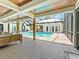 Extended covered patio with view of pool and natural wood supports, perfect for relaxation at 13710 Westshire Dr, Tampa, FL 33618