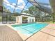 Enclosed pool area with an outdoor kitchen, offering the perfect space for relaxation and entertainment at 13710 Westshire Dr, Tampa, FL 33618