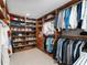 Spacious walk-in closet with custom shelves, drawers, and hanging rods for organization at 13710 Westshire Dr, Tampa, FL 33618