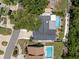Aerial view of a home featuring a backyard pool, mature trees, and a private outdoor space at 14030 79Th Ave, Seminole, FL 33776