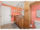 Hall bathroom featuring wood cabinets, granite countertops, and modern fixtures at 14030 79Th Ave, Seminole, FL 33776