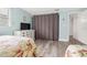 Comfortable guest bedroom with two beds, dresser, coastal decor, and lots of natural light at 14030 79Th Ave, Seminole, FL 33776