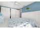 Light filled bedroom with white wainscoting and blue accent wall, featuring access to closet at 14030 79Th Ave, Seminole, FL 33776