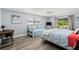 Bright bedroom with ensuite, light blue walls, and sliding door access to the pool area at 14030 79Th Ave, Seminole, FL 33776