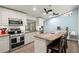 Well-equipped kitchen featuring stainless steel appliances, granite countertops, and a cozy breakfast bar at 14030 79Th Ave, Seminole, FL 33776