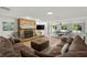 Cozy living room featuring a stone fireplace, comfortable sofa, and lots of natural light at 14030 79Th Ave, Seminole, FL 33776