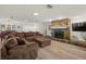 Spacious living room featuring a stone fireplace, comfortable sofa, and lots of natural light at 14030 79Th Ave, Seminole, FL 33776