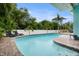 Inviting pool area surrounded by lush landscaping, lounge chairs, and a charming patio at 14030 79Th Ave, Seminole, FL 33776