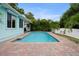 Beautiful pool with brick trim surrounded by tropical landscaping and a private fence at 14030 79Th Ave, Seminole, FL 33776