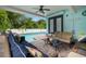 Inviting pool patio with comfortable seating, string lights, and a view of the private pool at 14030 79Th Ave, Seminole, FL 33776