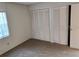 Bright bedroom featuring wood floors, neutral walls, and a set of white shuttered closet doors, adjacent to another set of closet doors at 14442 Reuter Strasse Cir # 812, Tampa, FL 33613