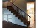 Wooden staircase with metal railing leading to the upper level at 14442 Reuter Strasse Cir # 812, Tampa, FL 33613