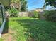 Lush backyard with fence, greenery, and flamingo decorations at 1448 Temple St, Clearwater, FL 33756