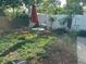 Relaxing backyard patio with furniture, greenery, and a white privacy fence at 1448 Temple St, Clearwater, FL 33756