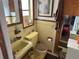 Retro bathroom featuring yellow fixtures and vintage tilework and a patterned floor at 1448 Temple St, Clearwater, FL 33756