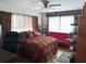 Comfortable bedroom with ample natural light and unique decor, featuring a ceiling fan and warm tones at 1448 Temple St, Clearwater, FL 33756