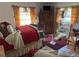 Bedroom featuring bright windows, wooden furniture and a bright red quilt at 1448 Temple St, Clearwater, FL 33756
