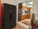 Features an open kitchen with wooden cabinets and tile floors with adjacent laundry area with modern appliances at 1448 Temple St, Clearwater, FL 33756