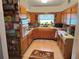 Bright kitchen with light wood cabinets, tile floors, and a window over the sink providing natural light at 1448 Temple St, Clearwater, FL 33756