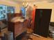 Traditional-style living room featuring a vintage dresser, hardwood floors, and classic decor with a glimpse to the exterior at 1448 Temple St, Clearwater, FL 33756