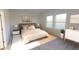 Serene bedroom with neutral tones, ample natural light, and modern nightstands with stylish lamps at 14710 Italy Ave, Dade City, FL 33523