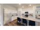 Modern kitchen with white cabinets, granite countertops, stainless steel appliances, and breakfast bar seating at 14710 Italy Ave, Dade City, FL 33523