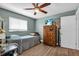 Cozy bedroom with stylish wood floors and a ceiling fan, creating a relaxing atmosphere at 1485 Lakeview Rd # 2, Clearwater, FL 33756