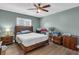 Comfortable bedroom featuring a wooden bed frame, side tables, and ceiling fan at 1485 Lakeview Rd # 2, Clearwater, FL 33756
