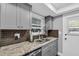 This updated kitchen has granite countertops, gray cabinets and stainless steel appliances at 1485 Lakeview Rd # 2, Clearwater, FL 33756