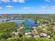 Picturesque aerial view of waterfront houses with swimming pools, lush trees, and winding waterways at 1531 75Th Ne Cir, St Petersburg, FL 33702