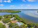 Scenic aerial view of waterfront homes with docks surrounded by trees and a body of water at 1531 75Th Ne Cir, St Petersburg, FL 33702