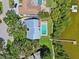 Aerial view of a waterfront property featuring a pool, dock, lush landscaping, and beautiful architectural design at 1531 75Th Ne Cir, St Petersburg, FL 33702