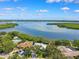 Expansive aerial view of waterfront homes surrounded by lush greenery and blue skies at 1531 75Th Ne Cir, St Petersburg, FL 33702