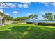 Beautiful backyard with a lush green lawn, leads up to waterfront with a wooden dock and access to the water at 1531 75Th Ne Cir, St Petersburg, FL 33702