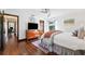 Bedroom with hardwood floors, ceiling fan, and access to hallways at 1531 75Th Ne Cir, St Petersburg, FL 33702