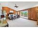 Bedroom features wood walls, carpet, and a sliding glass door to deck at 1531 75Th Ne Cir, St Petersburg, FL 33702