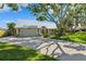Charming single-story home featuring a metal roof, a two-car garage, and a well-maintained lawn at 1531 75Th Ne Cir, St Petersburg, FL 33702