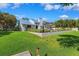 Stunning waterfront property with lush green lawn, beautiful landscaping, and gorgeous backyard on a sunny day at 1531 75Th Ne Cir, St Petersburg, FL 33702