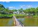 Waterfront home view from the wooden dock, surrounded by lush greenery, leading to the canal and home at 1531 75Th Ne Cir, St Petersburg, FL 33702